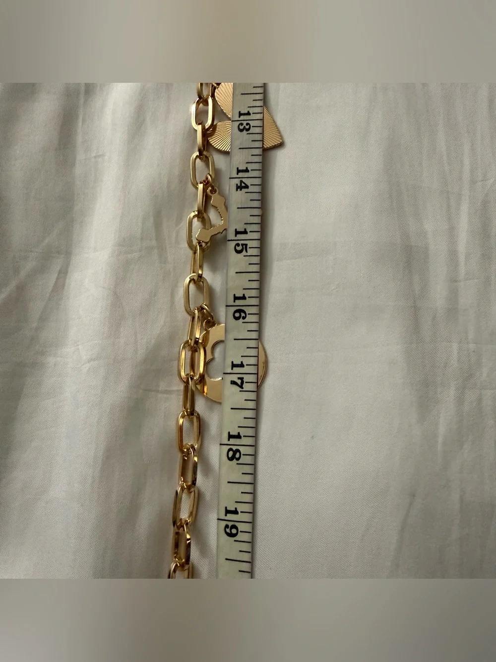 Gold tone metallic charms skinny chain belt